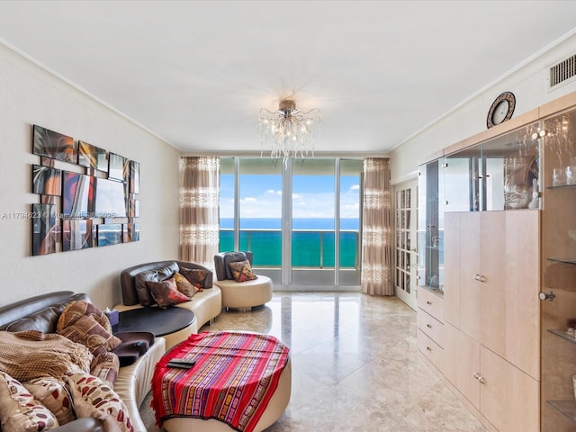 living area featuring crown molding, a notable chandelier, a wall of windows, a water view, and visible vents