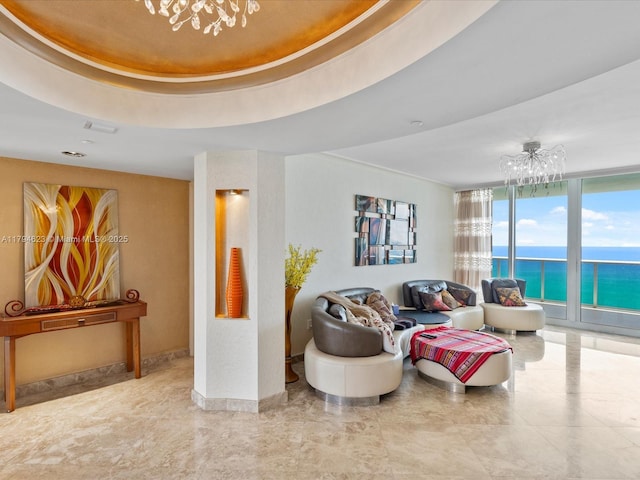 living area featuring a water view, a chandelier, and expansive windows