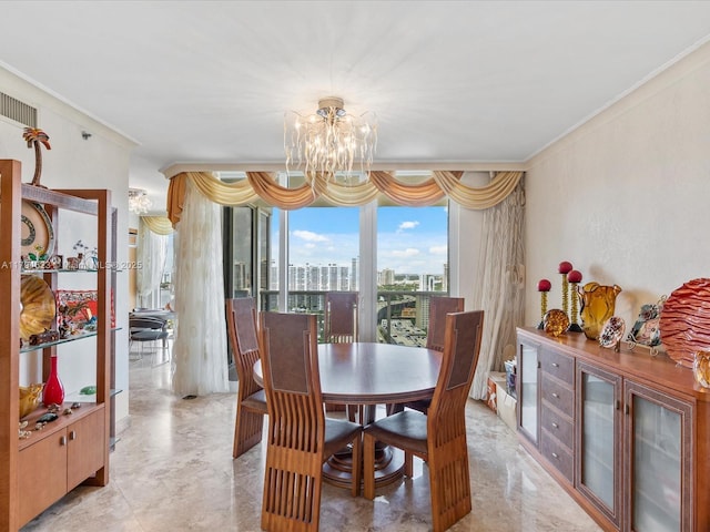 dining area featuring crown molding, a chandelier, and a city view