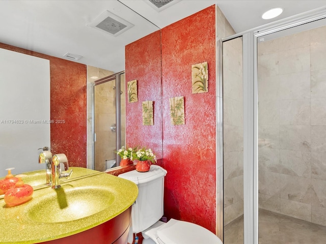 full bath featuring vanity, a shower stall, toilet, and visible vents