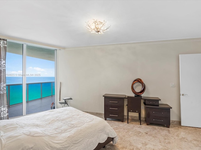 bedroom with a wall of windows and access to exterior