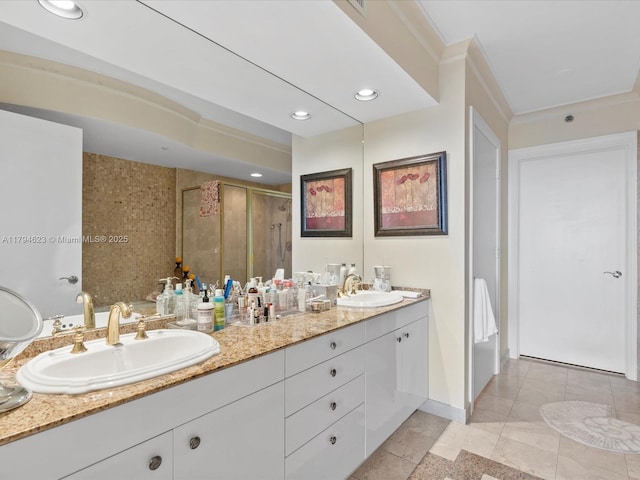 bathroom with double vanity, a sink, tile patterned flooring, and a shower stall
