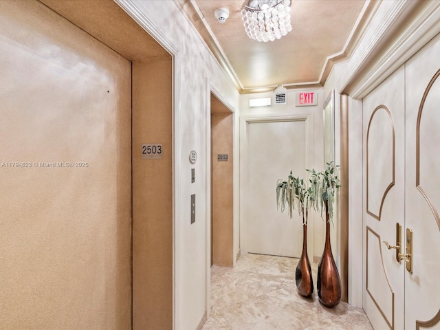 hallway featuring crown molding, baseboards, and elevator