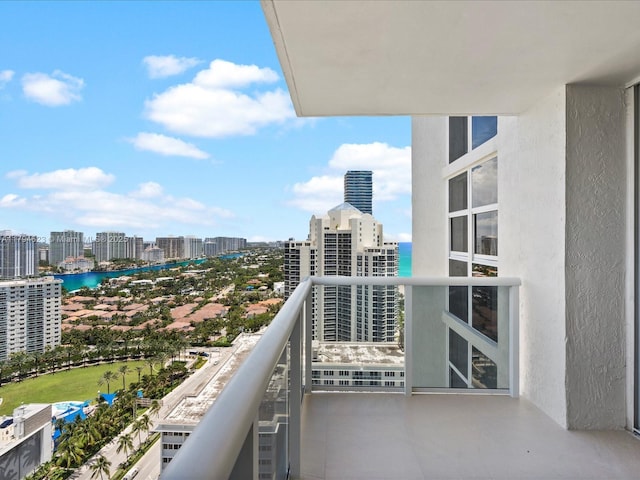 balcony featuring a view of city and a water view
