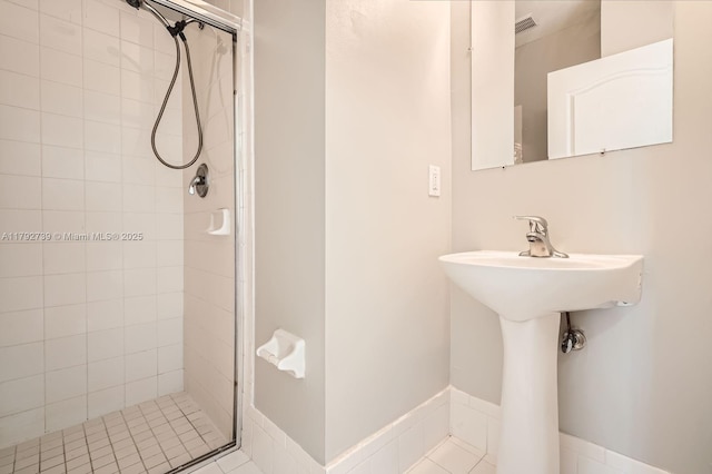 bathroom with a shower stall and a sink