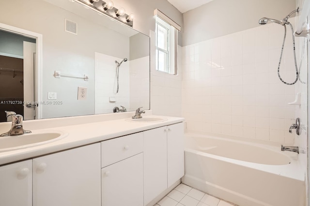 bathroom with visible vents, a sink, double vanity, and bathing tub / shower combination