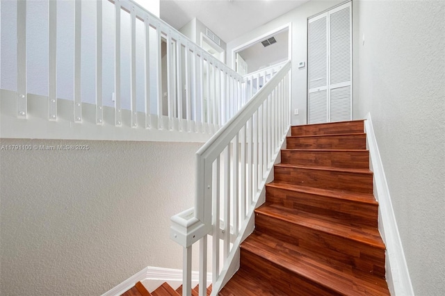 8904 SW 229th St, Cutler Bay, FL 33190 - staircase with baseboards, a textured wall, wood finished floors, and visible vents