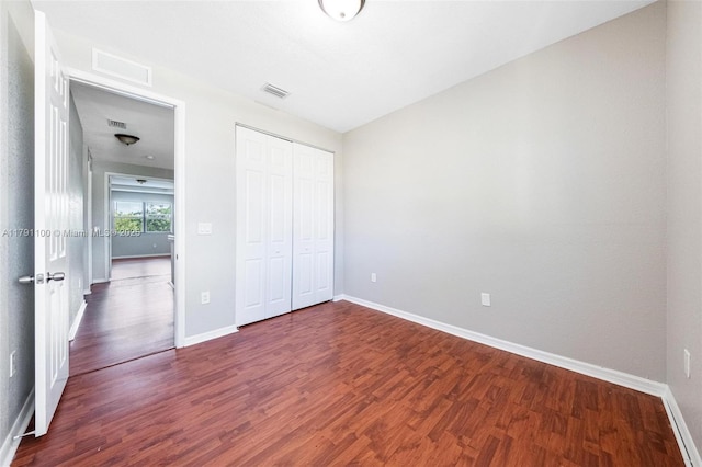 8904 SW 229th St, Cutler Bay, FL 33190 - unfurnished bedroom with baseboards, a closet, dark wood finished floors, and visible vents