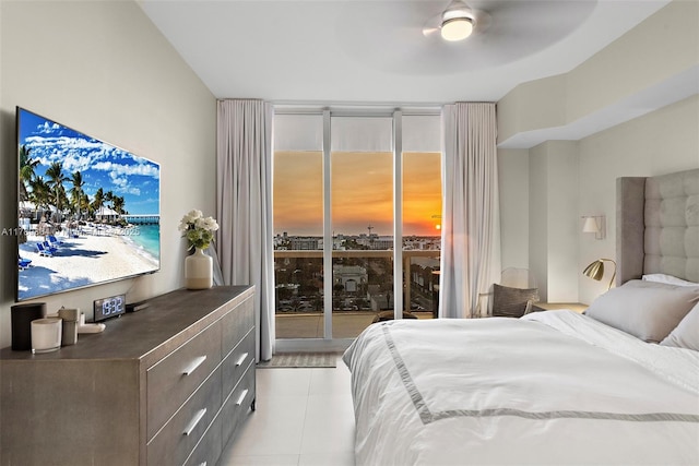 bedroom with floor to ceiling windows and light tile patterned flooring