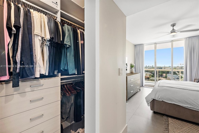 tiled bedroom featuring floor to ceiling windows
