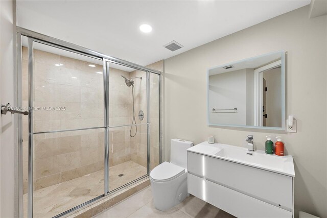 bathroom featuring tile patterned flooring, vanity, toilet, visible vents, and a stall shower