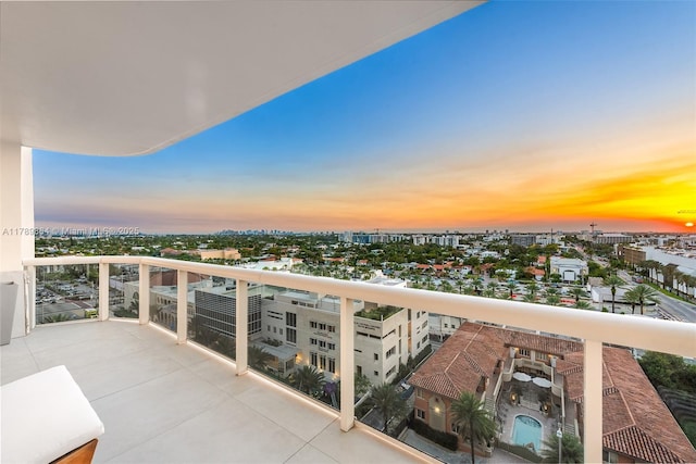 balcony at dusk with a view of city