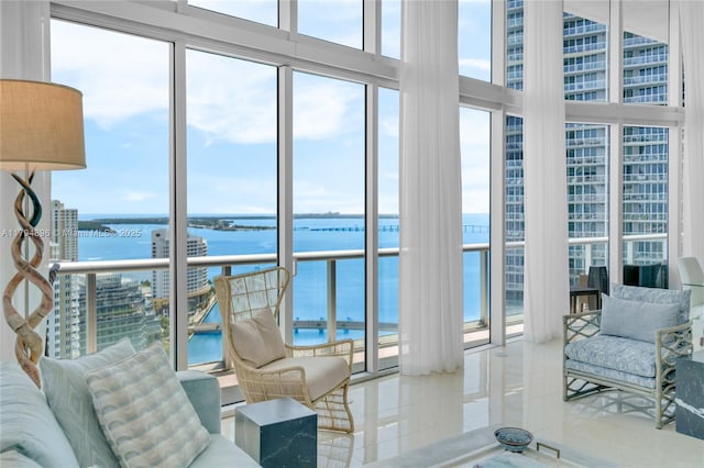 465 Brickell Ave Unit 2801, Miami, FL 33131 - tiled living room featuring a water view, floor to ceiling windows, a high ceiling, and a wealth of natural light
