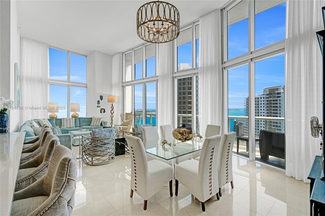 465 Brickell Ave Unit 2801, Miami, FL 33131 - dining room featuring a water view, a chandelier, a wall of windows, and light tile patterned floors