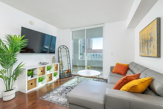 living area with baseboards, wood finished floors, and a wall of windows