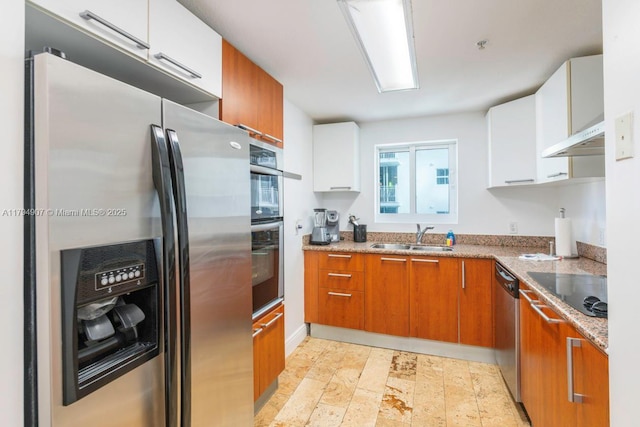 kitchen featuring a sink, white cabinetry, brown cabinets, and stainless steel appliances