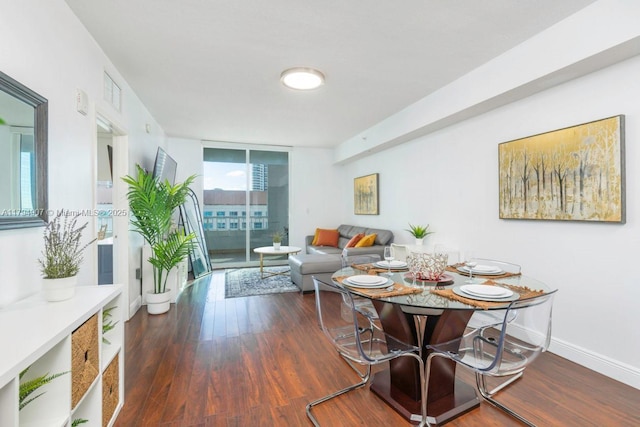 dining space featuring baseboards, visible vents, and wood finished floors