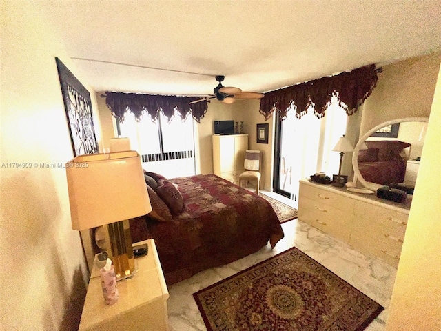 bedroom featuring a ceiling fan, a textured ceiling, marble finish floor, radiator, and access to outside