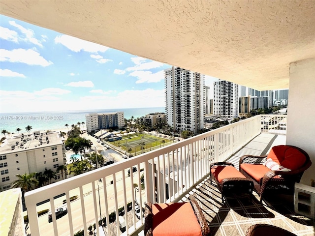 balcony featuring a view of city and a water view