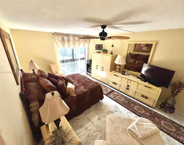 bedroom with a textured ceiling, access to exterior, ceiling fan, and marble finish floor