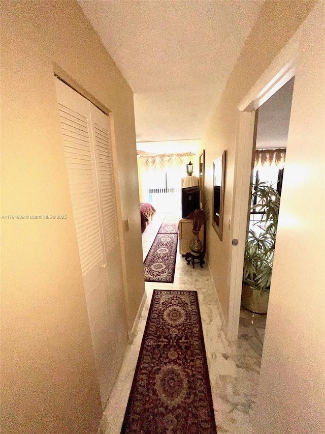 hall with a textured ceiling