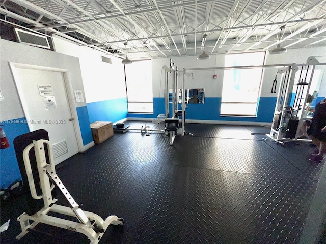 workout area featuring baseboards and visible vents