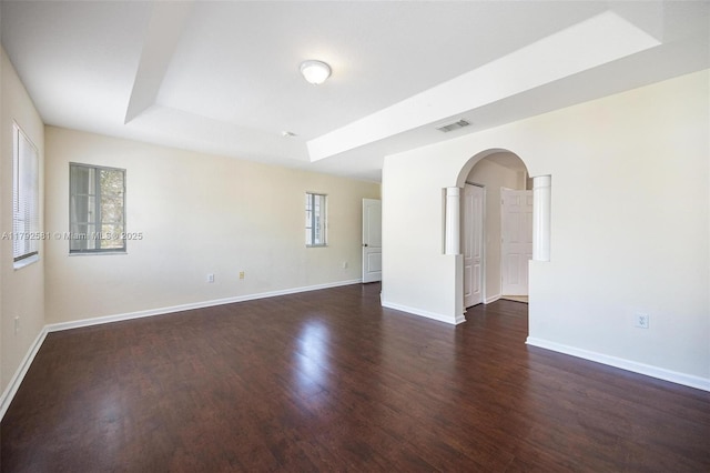 27056 SW 140th Pl, Homestead, FL 33032 - empty room with dark wood-style flooring, arched walkways, and baseboards