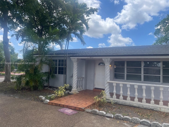 view of front of house featuring roof with shingles