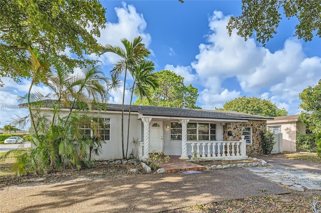 7740 Shalimar St, Miramar, FL 33023 - ranch-style house with stucco siding, a porch, and stone siding