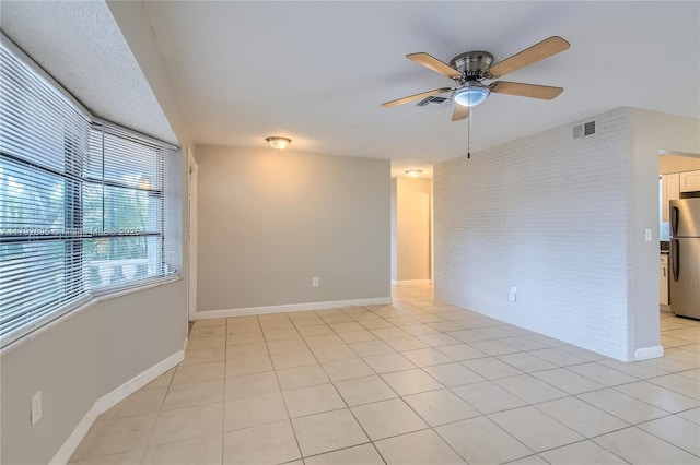7740 Shalimar St, Miramar, FL 33023 - spare room with visible vents, ceiling fan, light tile patterned floors, and brick wall
