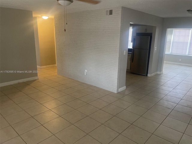 unfurnished room featuring visible vents, baseboards, and light tile patterned floors