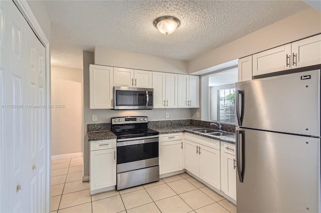 7740 Shalimar St, Miramar, FL 33023 - kitchen featuring a sink, appliances with stainless steel finishes, a textured ceiling, and white cabinetry