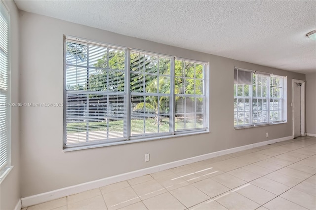 7740 Shalimar St, Miramar, FL 33023 - empty room with light tile patterned floors, a textured ceiling, and a wealth of natural light