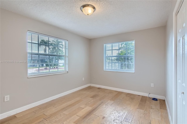 7740 Shalimar St, Miramar, FL 33023 - empty room featuring a textured ceiling, a wealth of natural light, and light wood-type flooring