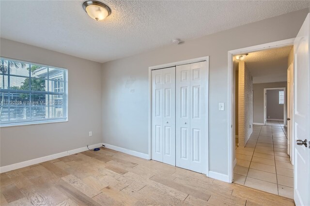 7740 Shalimar St, Miramar, FL 33023 - unfurnished bedroom featuring baseboards, a closet, light wood-type flooring, and a textured ceiling