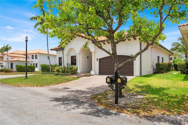 7745 SW 188th Ter, Cutler Bay, FL 33157 - mediterranean / spanish home with driveway, a garage, stucco siding, and a front yard