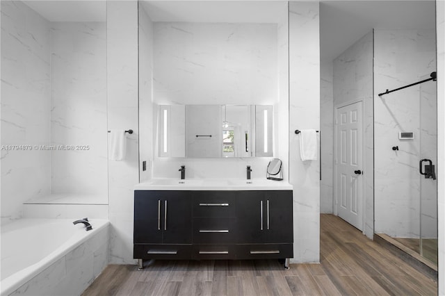 7745 SW 188th Ter, Cutler Bay, FL 33157 - full bath featuring a sink, wood finished floors, a marble finish shower, double vanity, and a garden tub