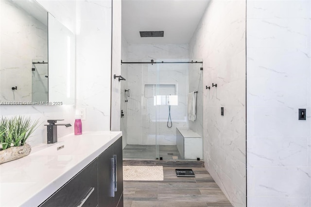 7745 SW 188th Ter, Cutler Bay, FL 33157 - bathroom with a marble finish shower, vanity, visible vents, and wood finished floors