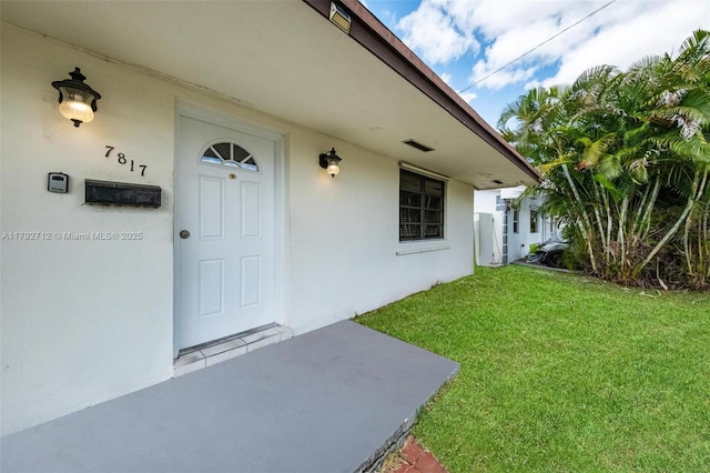 7817 NE Madeira St, Miramar, FL 33023 - doorway to property featuring a lawn and stucco siding