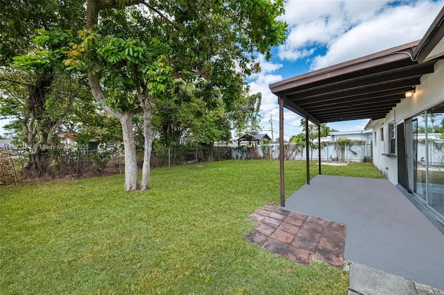 7817 NE Madeira St, Miramar, FL 33023 - view of yard featuring a fenced backyard and a patio