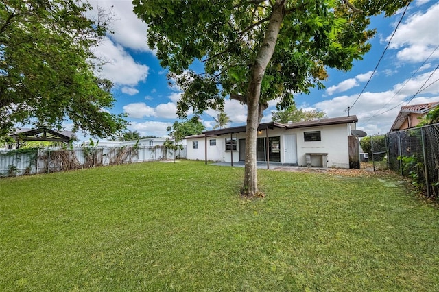 7817 NE Madeira St, Miramar, FL 33023 - view of yard featuring a fenced backyard