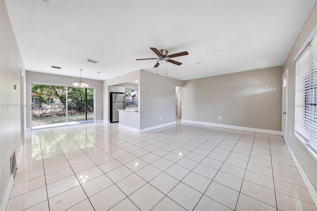 7817 NE Madeira St, Miramar, FL 33023 - spare room featuring baseboards, ceiling fan with notable chandelier, light tile patterned floors, and visible vents
