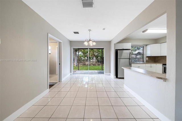 7817 NE Madeira St, Miramar, FL 33023 - kitchen with a chandelier, stainless steel appliances, baseboards, backsplash, and visible vents