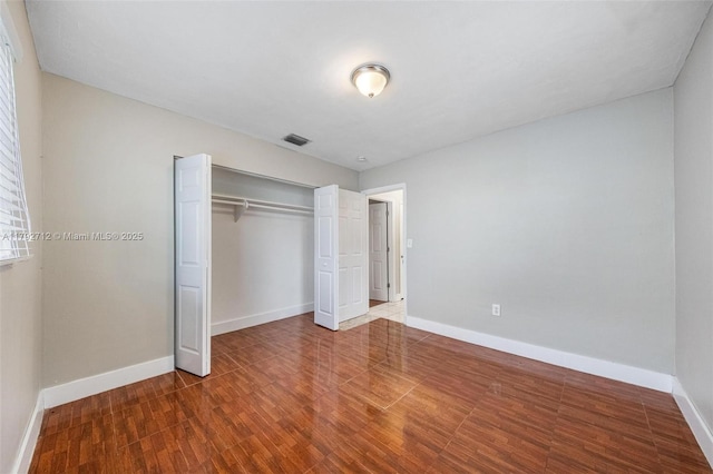7817 NE Madeira St, Miramar, FL 33023 - unfurnished bedroom featuring baseboards, a closet, wood finished floors, and visible vents