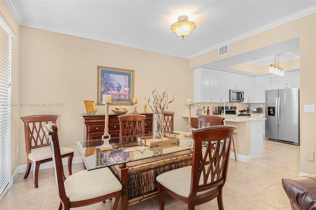 dining room with visible vents, ornamental molding, baseboards, and light tile patterned floors