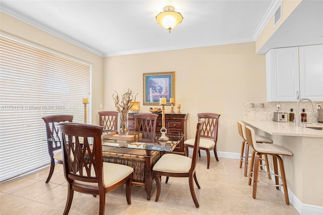 dining area with visible vents, ornamental molding, baseboards, and light tile patterned flooring
