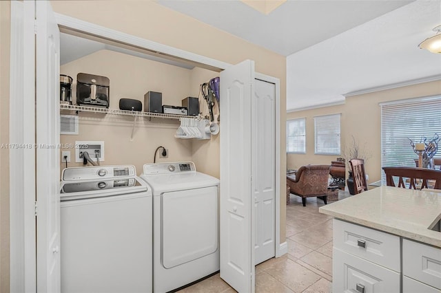 washroom with laundry area, washer and clothes dryer, and light tile patterned flooring