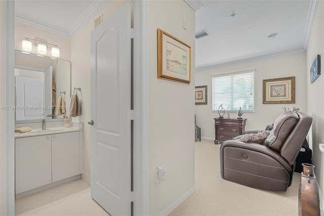 sitting room featuring crown molding, baseboards, and visible vents