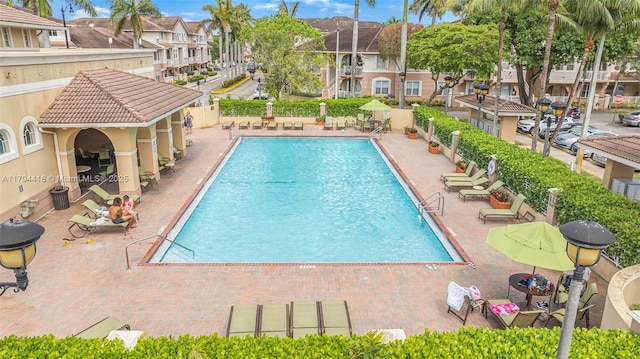 pool featuring a residential view and a patio area