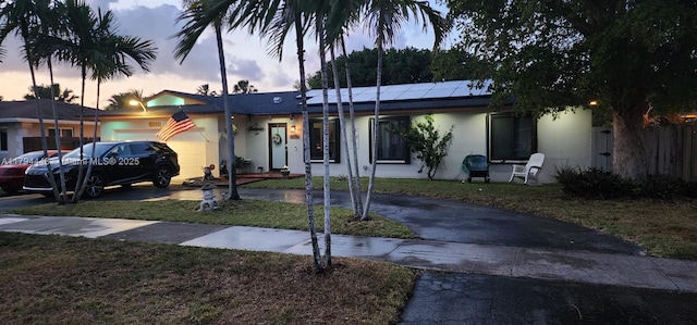 8111 SW 205th St, Cutler Bay, FL 33189 - ranch-style house featuring a yard, driveway, solar panels, and stucco siding